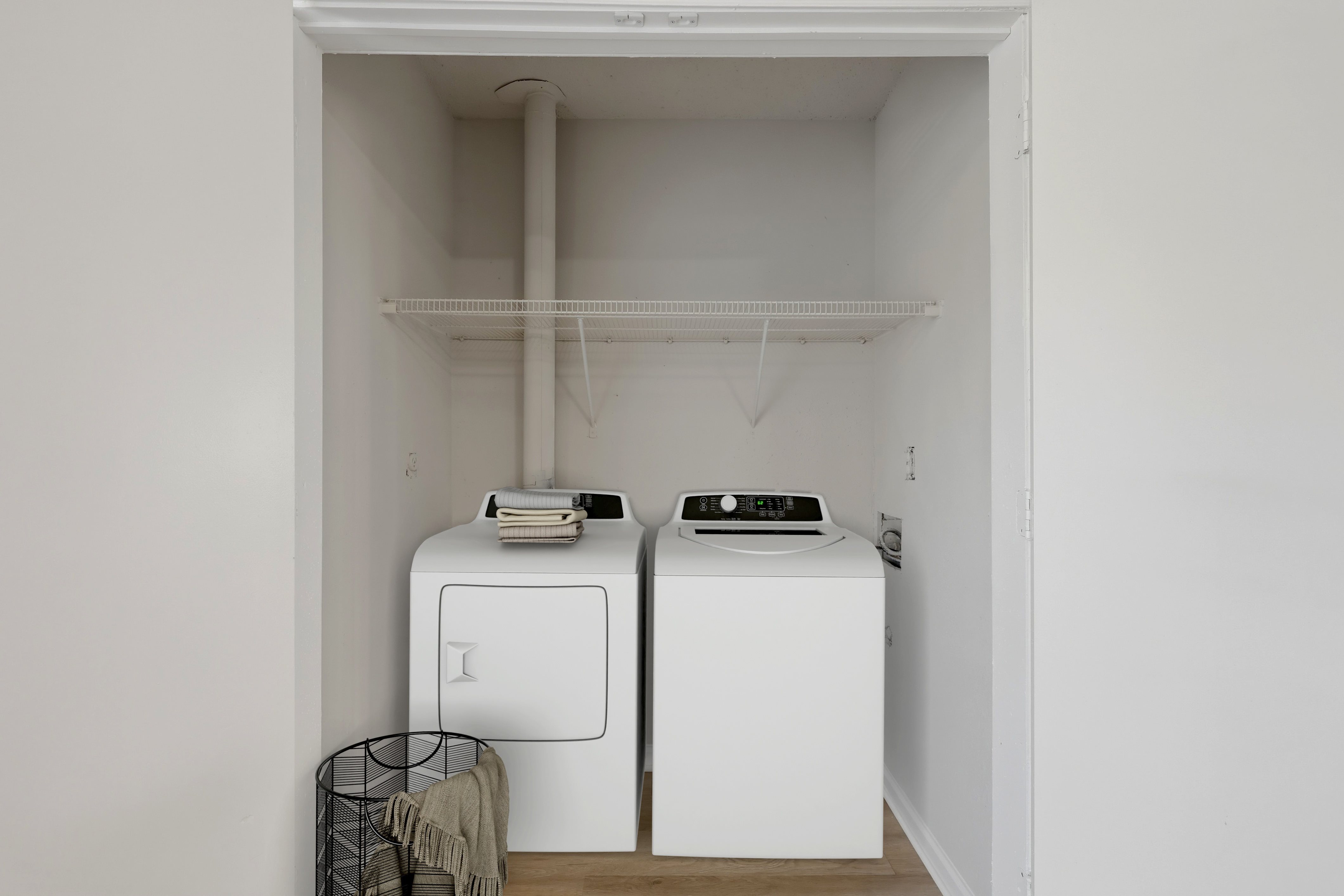 A small laundry room with a washer and dryer.